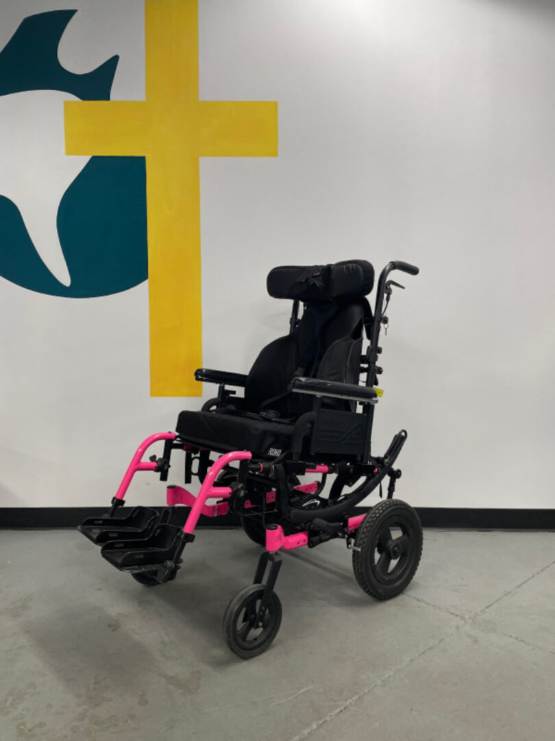 The Side View of a Wheel Chair in Black Color Pink Details